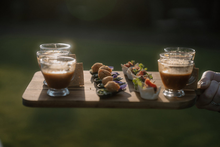 Wedding canapés and drinks served on a wooden tray during a reception at Auchen Castle.
