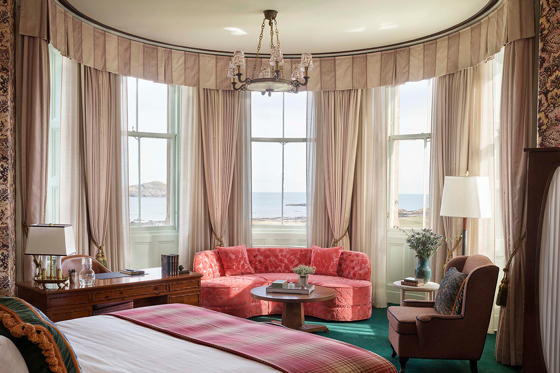Luxury bedroom at Marine North Berwick with bay windows, lounge seating and sea views