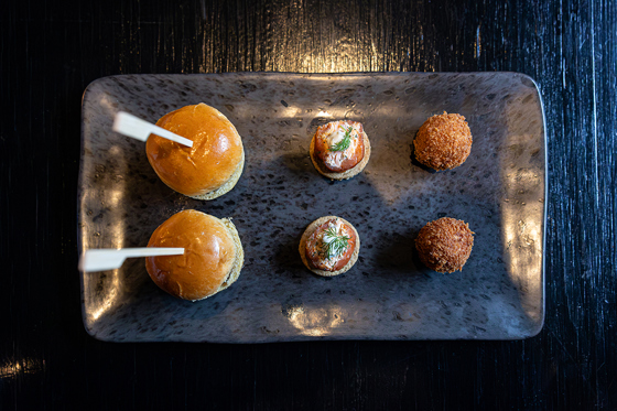 Wedding canapés served on a platter at Melville Castle, including mini sliders, smoked salmon bites and crispy bites.
