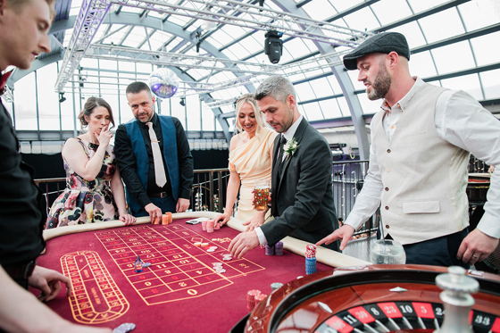 Wedding guests participate in a game of poker on Mezzanine at Barra's Art and Design.