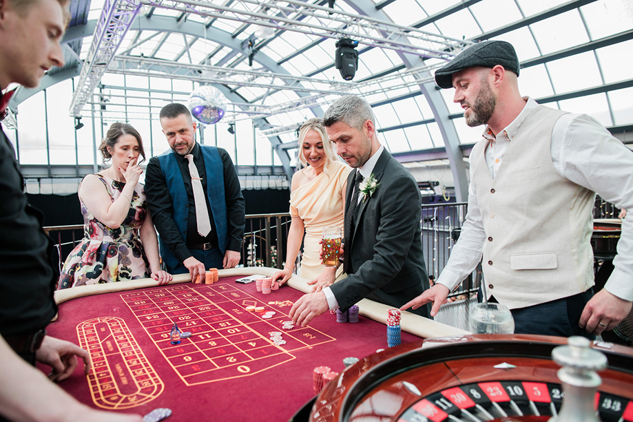 Wedding guests participate in a game of poker on Mezzanine at Barra's Art and Design.
