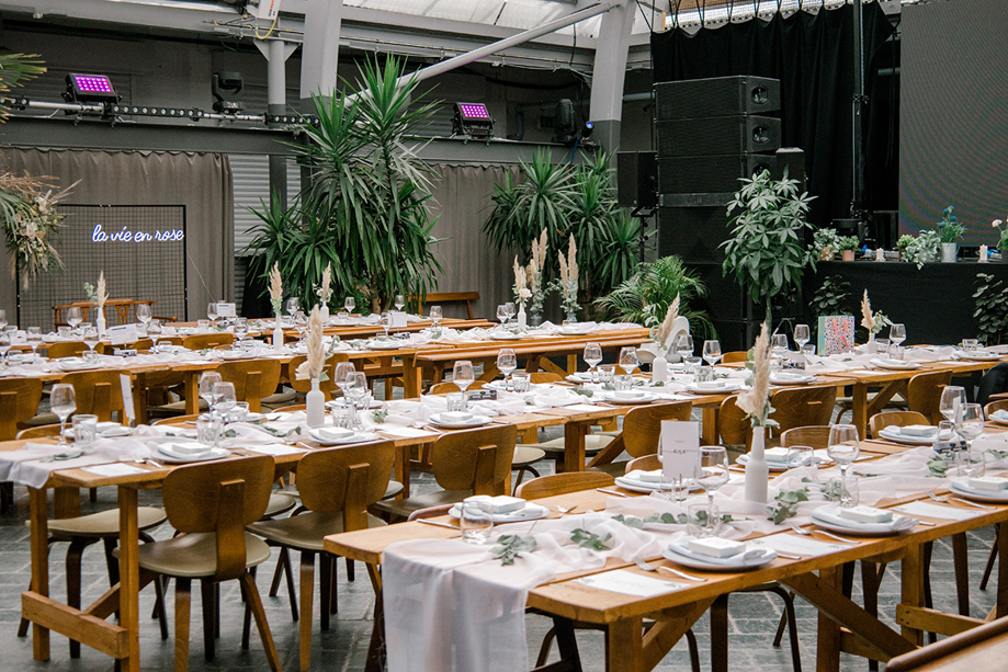 Wedding meal set up on wooden tables with white and green decor at BAaD Glasgow.