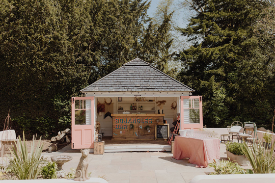Vintage Bojangles garden bar at Netherbyres House set up for outdoor drinks reception at a summer wedding