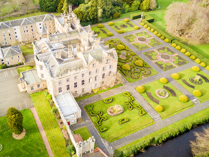 Aerial view of Newbattle Abbey College wedding venue with formal gardens and historic building in Midlothian Scotland