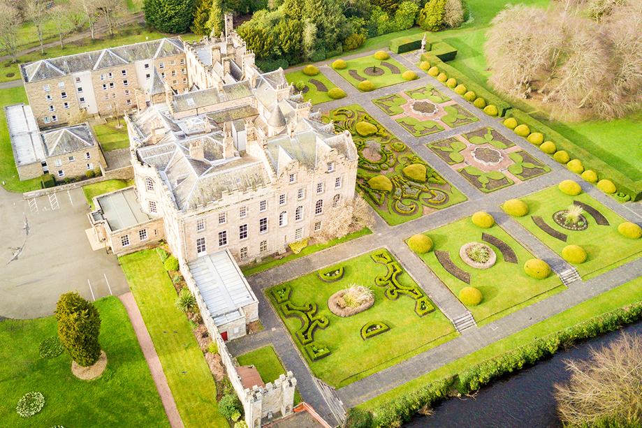 Aerial view of Newbattle Abbey College wedding venue with formal gardens and historic building in Midlothian Scotland