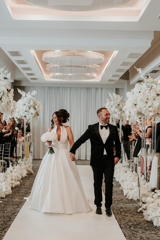 Bride and groom walking back up aisle together at Riverside Lodge Hotel