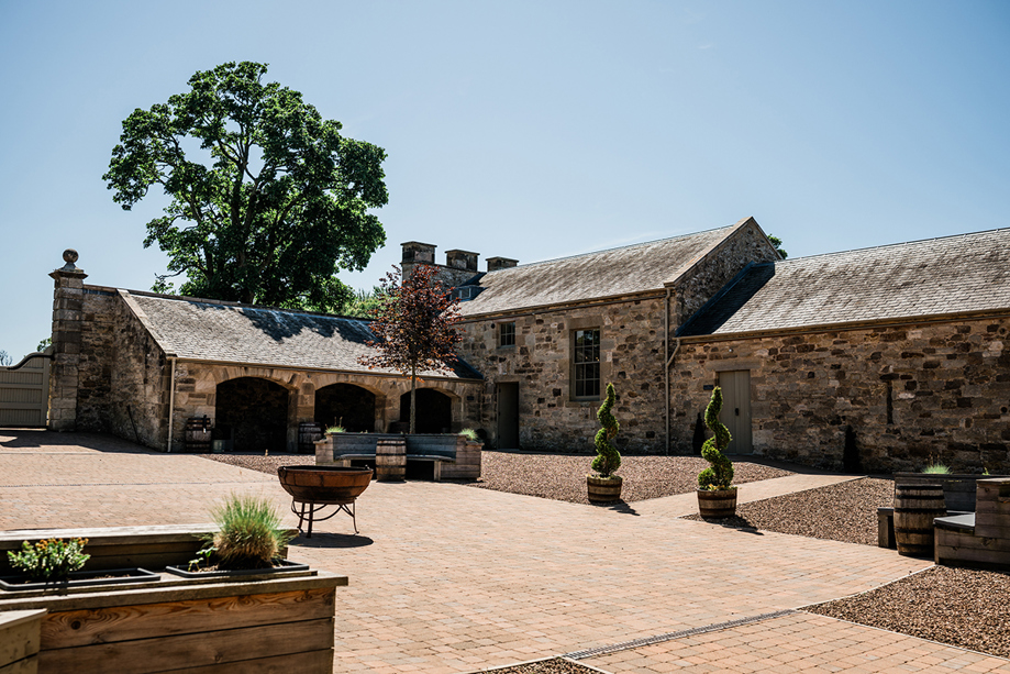 Courtyard and stone buildings at Rosebery House wedding venue in Midlothian countryside