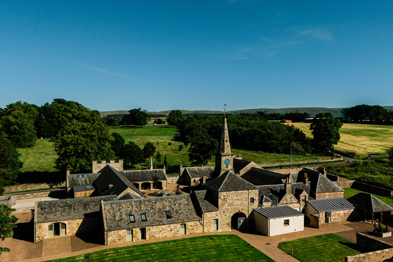 Aerial view of Rosebery House wedding venue surrounded by rolling countryside and landscaped grounds