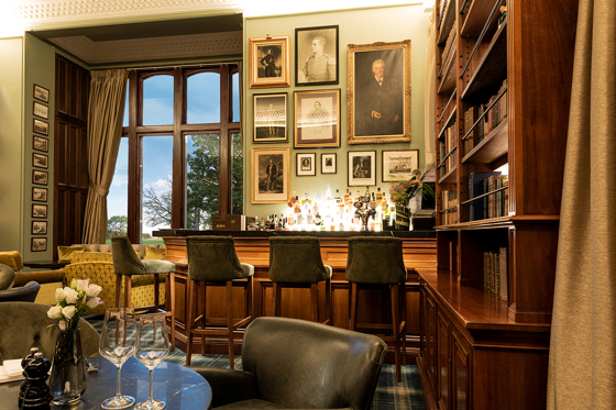 Bar area within SCHLOSS Roxburghe with original features and old paintings on walls.
