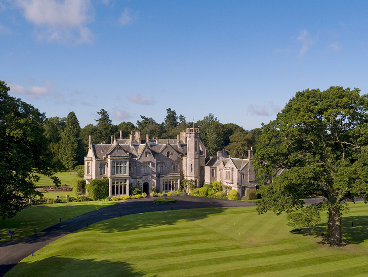 Exterior view of Schloss Roxburghe in the Scottish Borders, a country house hotel wedding venue with manicured lawns.