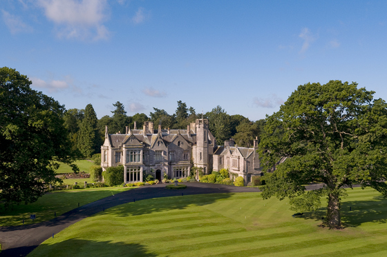 Exterior view of Schloss Roxburghe in the Scottish Borders, a country house hotel wedding venue with manicured lawns.