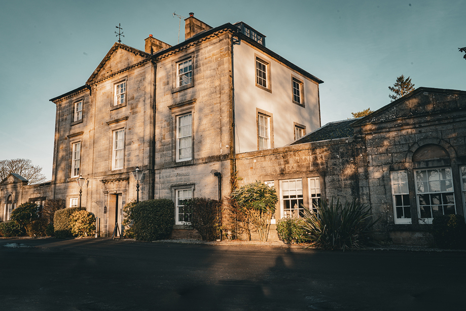 Exterior view of Strathaven Hotel, a historic country house wedding venue in South Lanarkshire with classic stone architecture.