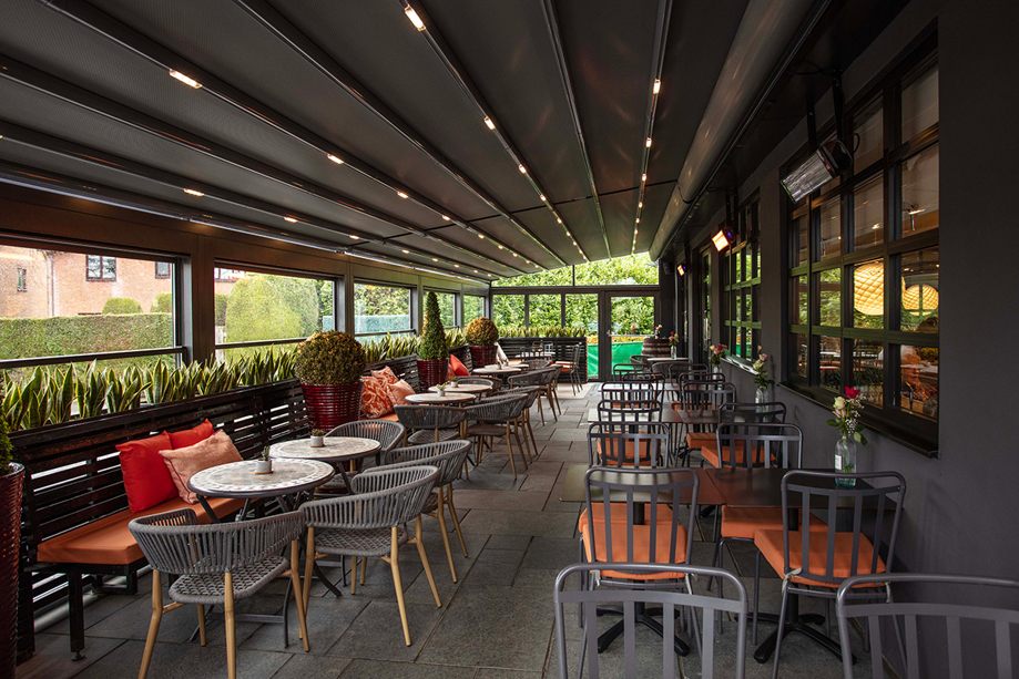 Covered outdoor terrace seating at Strathaven Hotel, a relaxed space for wedding guests to enjoy drinks during receptions.