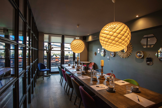 Private dining room at Strathaven Hotel styled for a wedding meal with long banquet table and warm contemporary lighting.