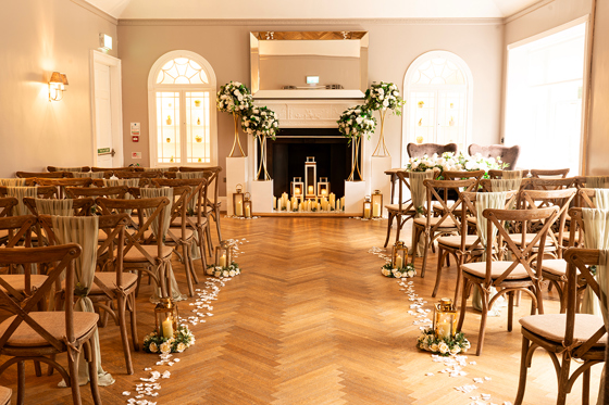 Romantic wedding ceremony at Strathaven Hotel with candlelit fireplace, floral arrangements and aisle décor.