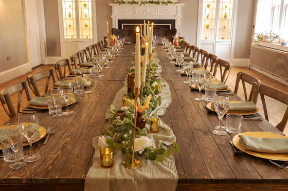 Wedding banquet table at Strathaven Hotel styled with sage green accents, gold details and candle centrepieces.