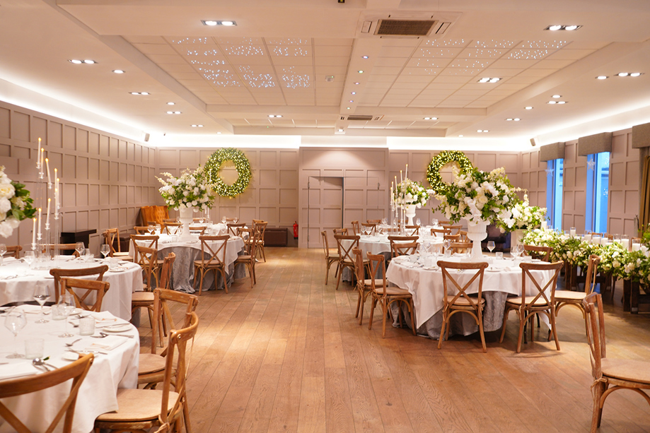 Wedding reception dining setup at Strathaven Hotel with round tables, floral centrepieces and elegant event styling.