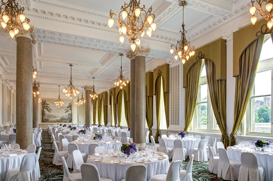 Elegant wedding breakfast room at The Balmoral Hotel Edinburgh with chandeliers, white linens and floral table styling