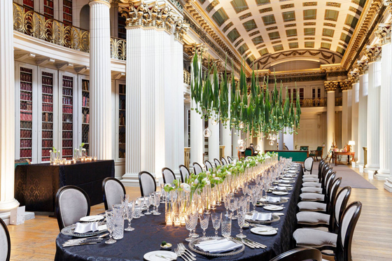 Long table decorated with hanging tulips and tulips with fairy lights lining the middle of the table