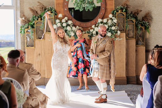Bride celebrates after "I do" at the altar at The Waterside Hotel