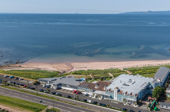 Drone view of The Waterside Hotel & Spa and its surrounding water.