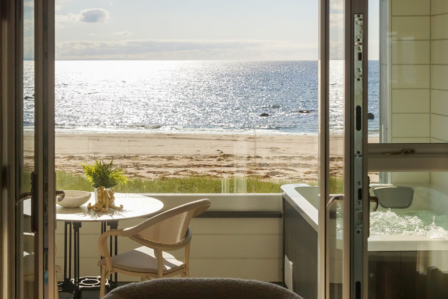View of the beach and seaside with hottub on balcony at The Waterside Hotel