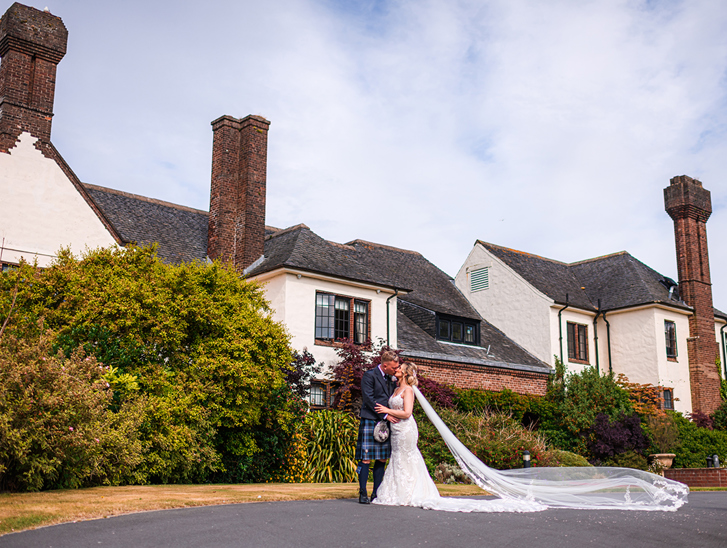 Bride and groom kiss outside Western House Hotel, a wedding venue in Ayrshire.