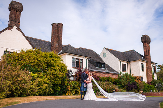 Bride and groom kiss outside Western House Hotel, a wedding venue in Ayrshire.