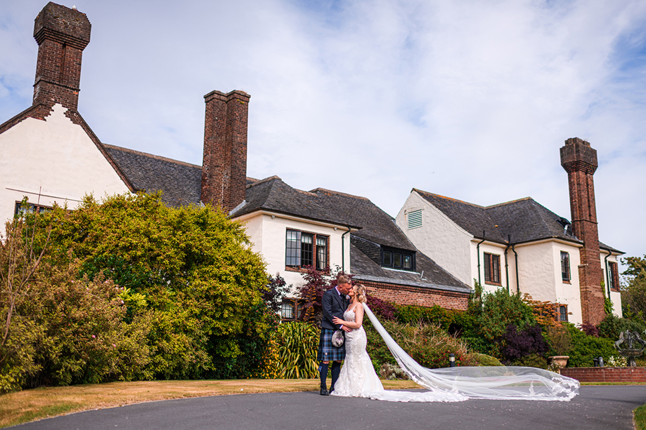 Bride and groom kiss outside Western House Hotel, a wedding venue in Ayrshire.