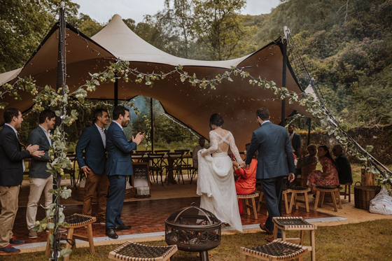Bride walking down the aisle at an outdoor Castle Craigard wedding ceremony