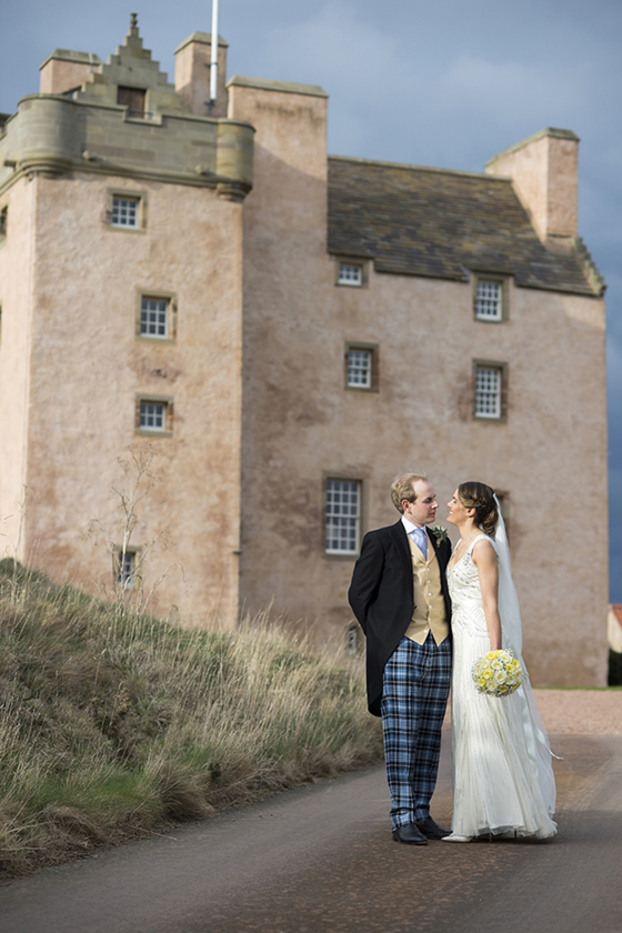 Bride and groom portrait outside Fenton Tower, with the historic Scottish wedding venue in the background