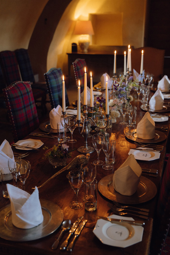 Formal dining setup inside Fenton Tower’s vaulted dining room with long banquet table and candlelit atmosphere