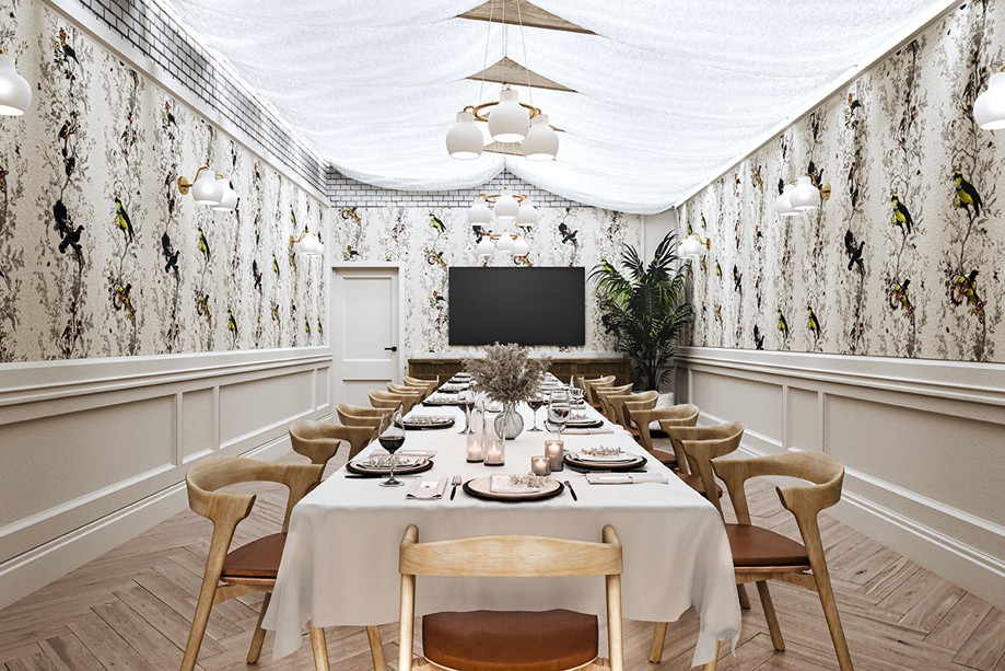 Wedding meal set up at The Collector's Hall in room with long table, wooden and maroon seats, draped ceiling with hanging lights and bird wallpaper.