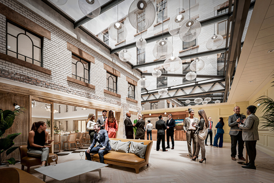 People stand in The Treasury at The Collector's Hall, a space adjoined to the Main Hall and features a glass ceiling, exposed brickwork and a bright, airy feel.