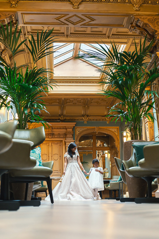Bride holds her flower girl's hand before walking down the aisle at The Scott Hotel.