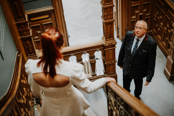 Bride walks down stairs to her emotional father at The Scott Hotel.